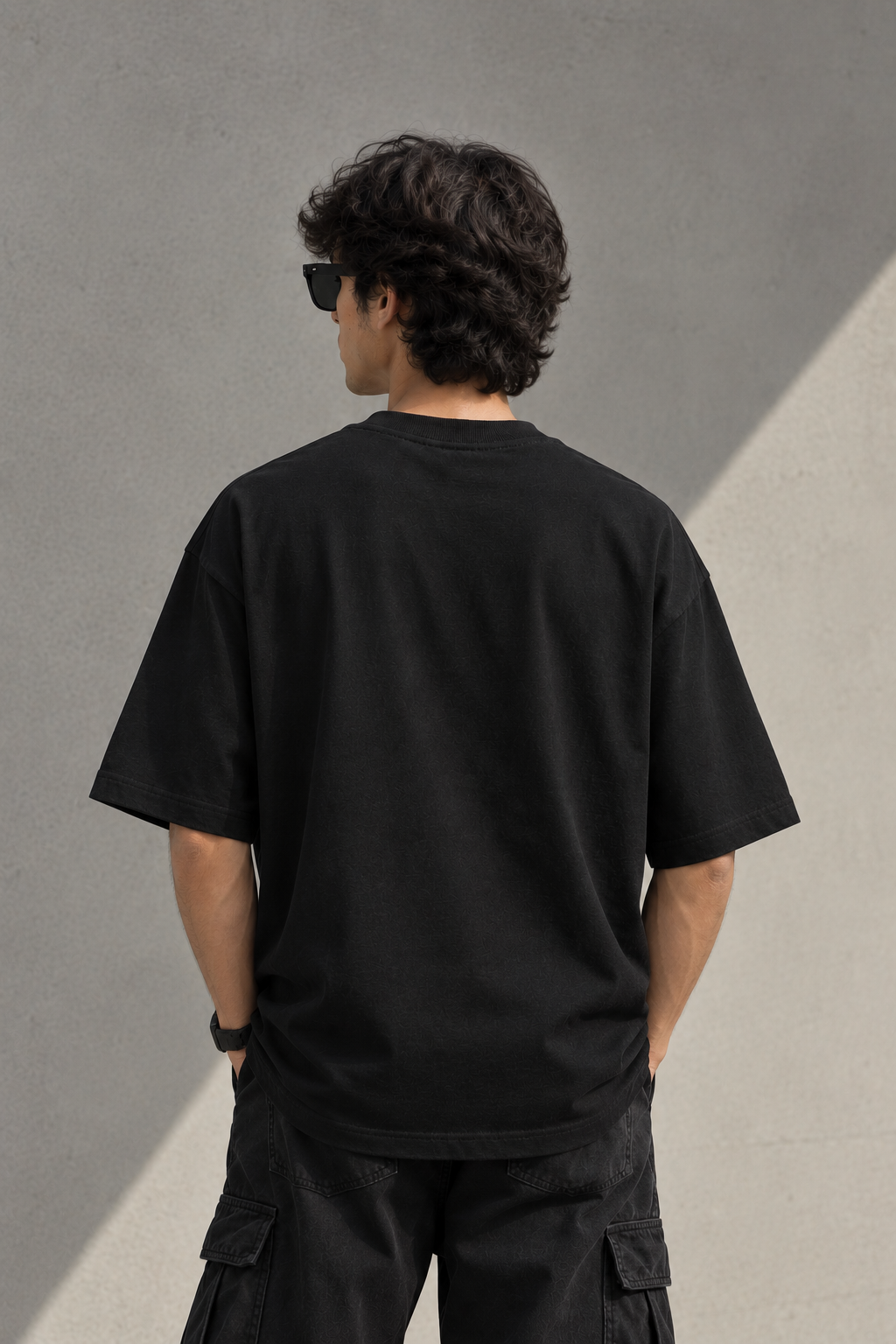 Man wearing Known Clothing black oversized t-shirt back view  
