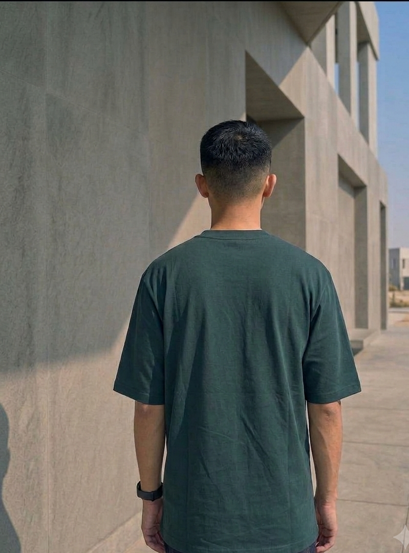 Known Clothing green oversized t-shirt back view on male model outdoor setting